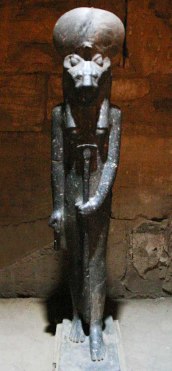 Statue of Sekhmet in small chapel near the temple of Ptah in Karnak. The statue is illuminated only by a small hole in the ceiling, adding to the mysterious atmosphere of the shrine.